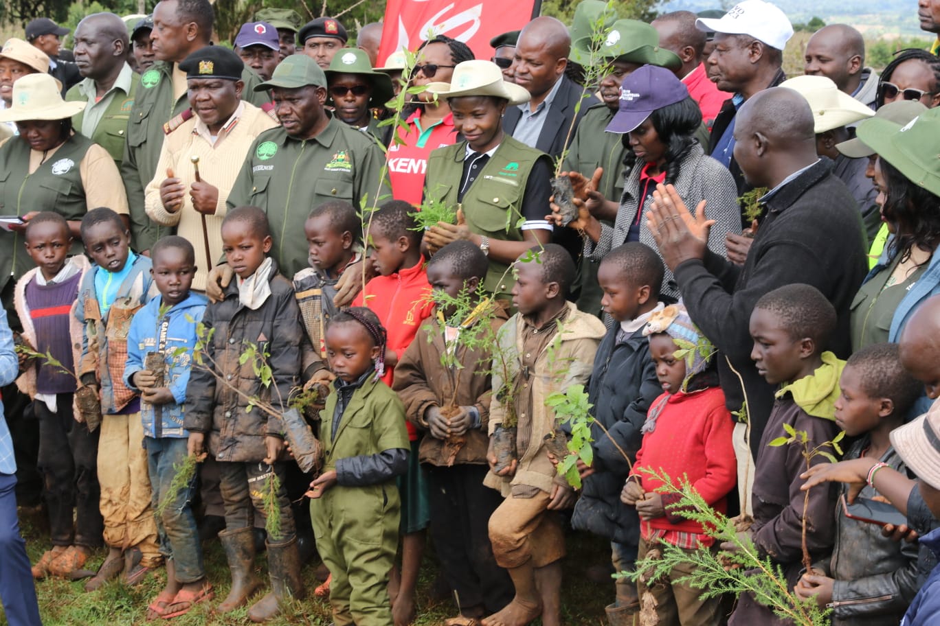 Governor Jonathan Bii in presence of PS Susan Mang'eni during tree planting exercise in Uasin Gishu and general public