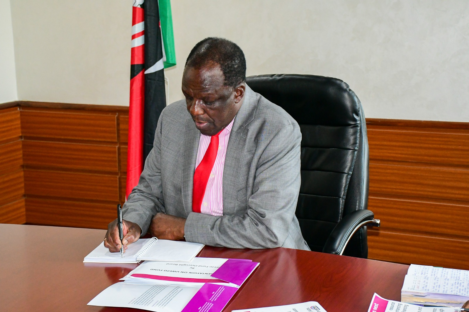 Hon. Wycliffe Oparanya takes notes during Uwezo Fund meeting brief