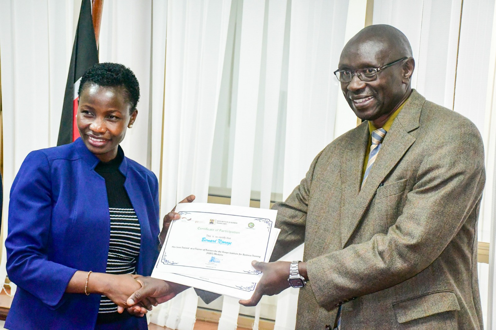 PS MSME and Mr. Patrick Nyakundi showcasing certificates of training of trainers