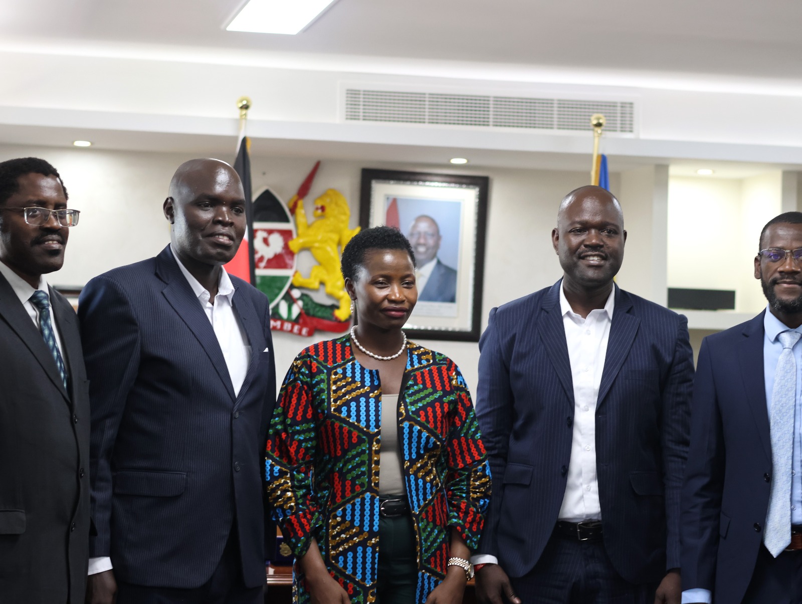 The Principal Secretary MSME and members of Busia Professional Association pose for photos after fruitful deliberations