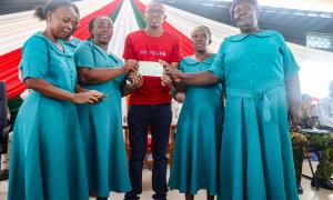 Uwezo Fund Nyali beneficiary group pose for a photo amongst MP Nyali